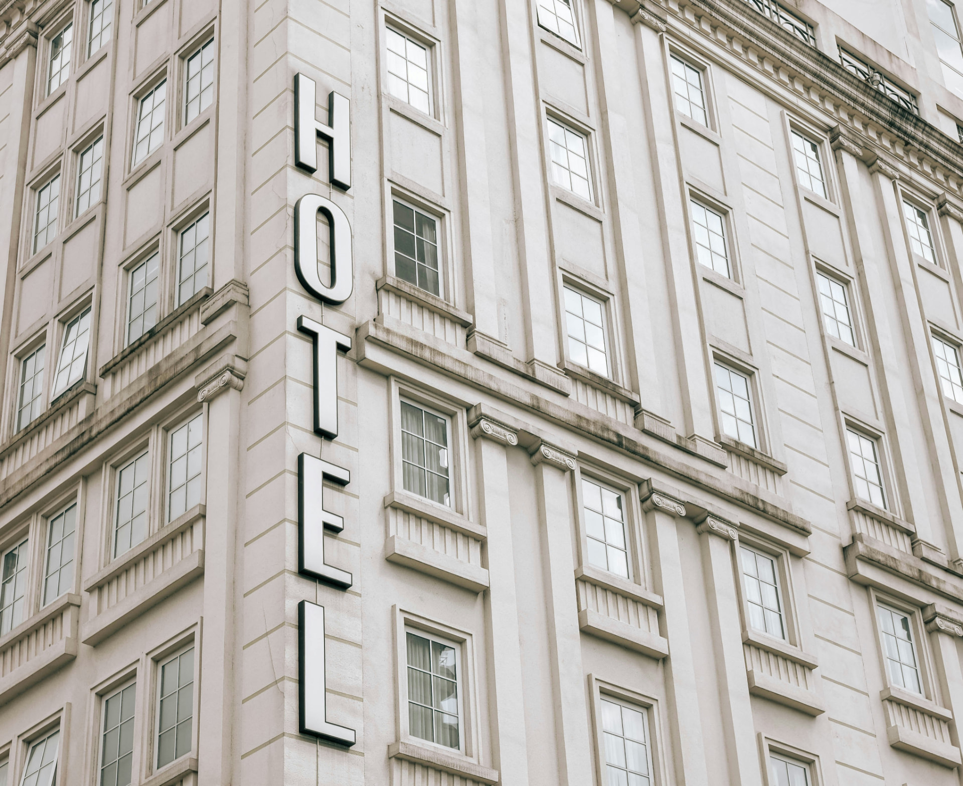 Hotel sign on the corner facade of a classical stone building