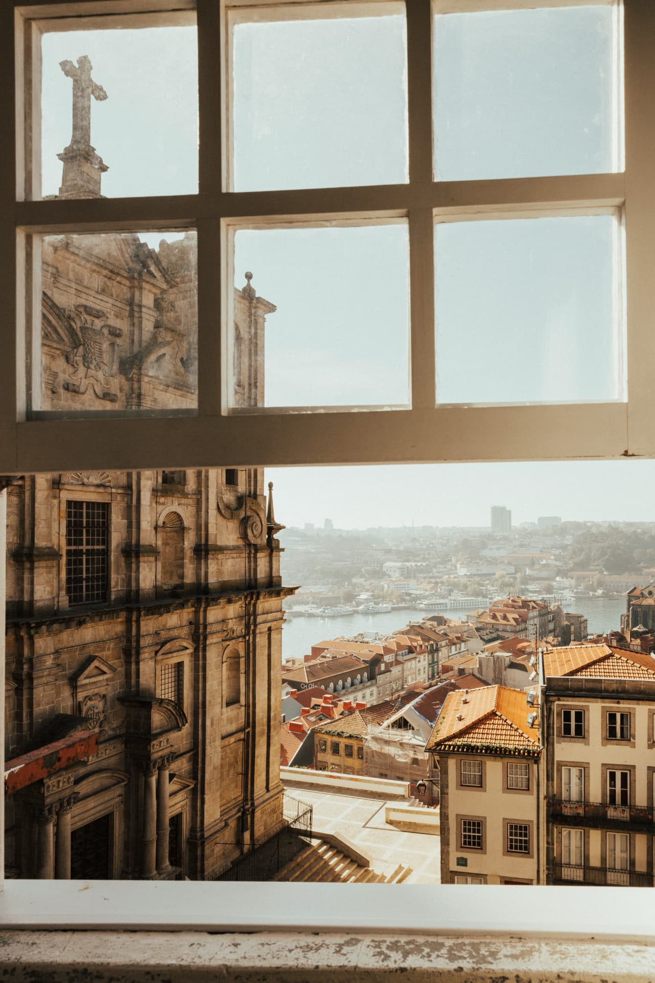 View of Porto rooftops through a window
